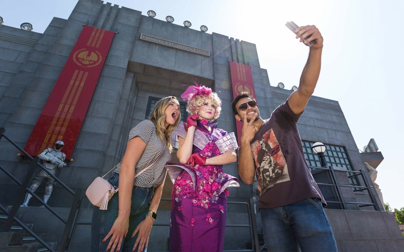 Tourists taking a selfie with a character at the Hunger Games ride, Motiongate Dubai.