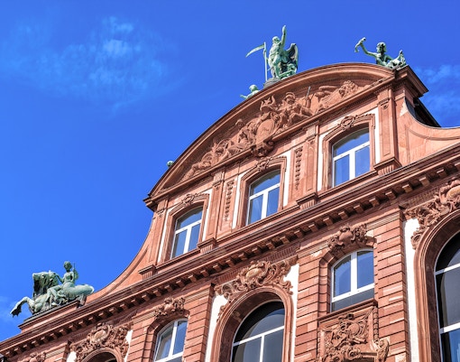 Senckenberg Museum Frankfurt facade with ornate sculptures and blue sky.