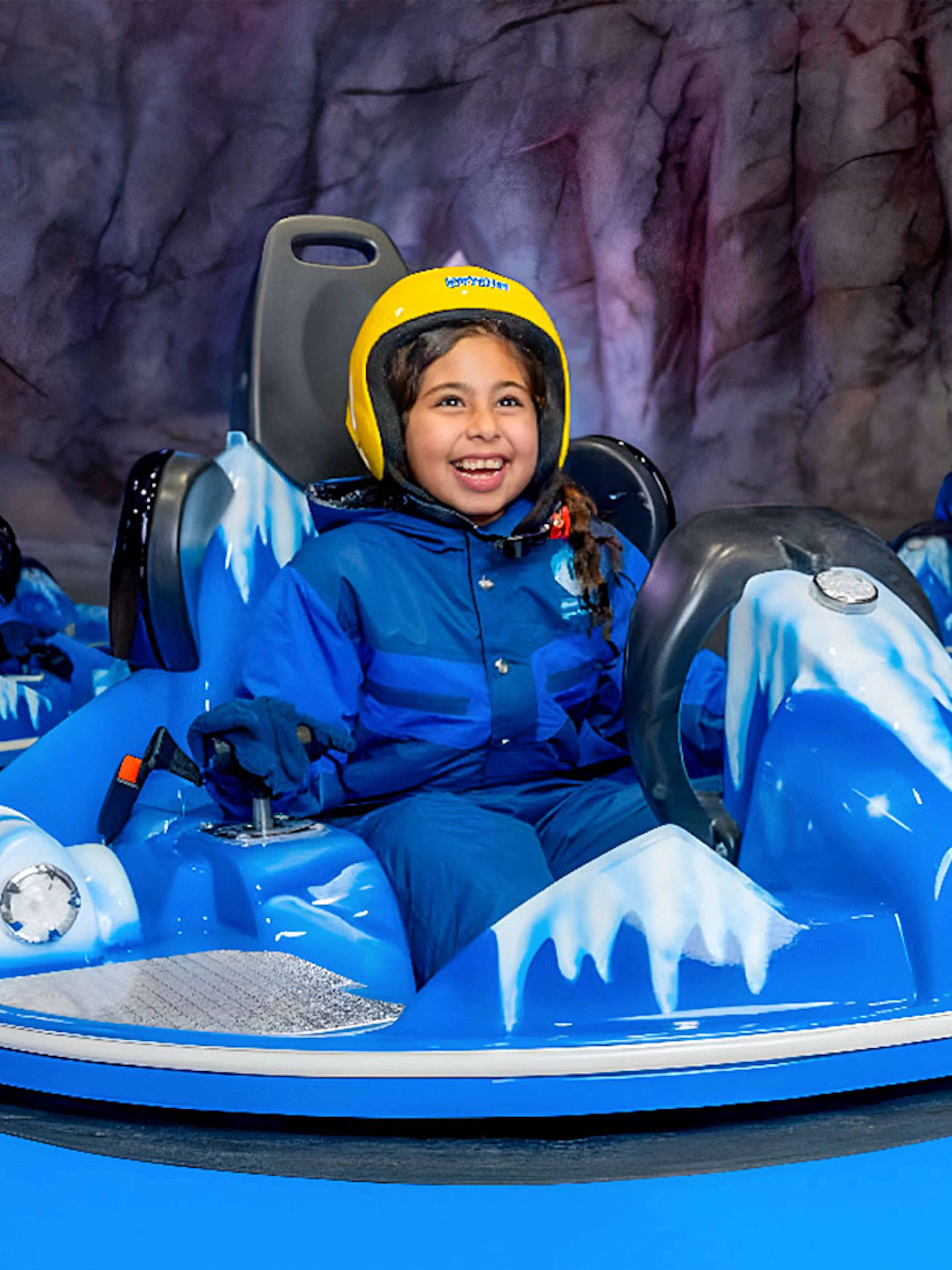 Children and adults enjoying bumper cars at Snow Abu Dhabi's Snow Park.