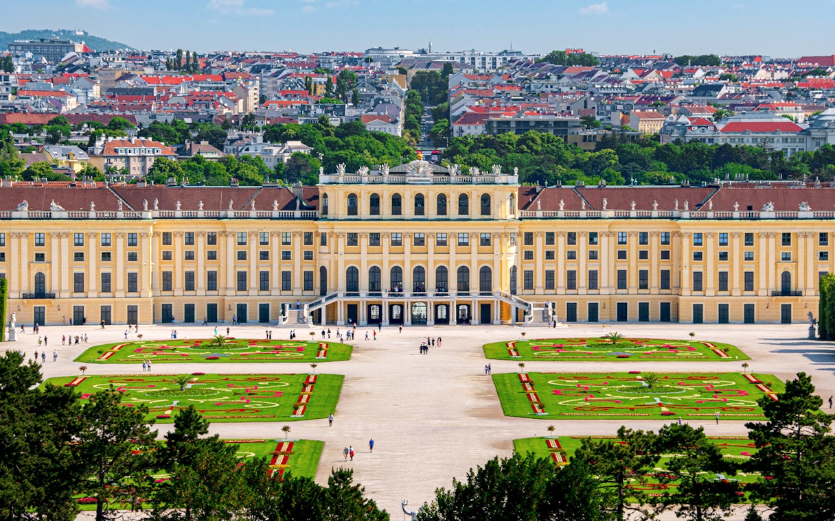 Aerial view of Schönbrunn Palace gardens and facade in Vienna, Austria.