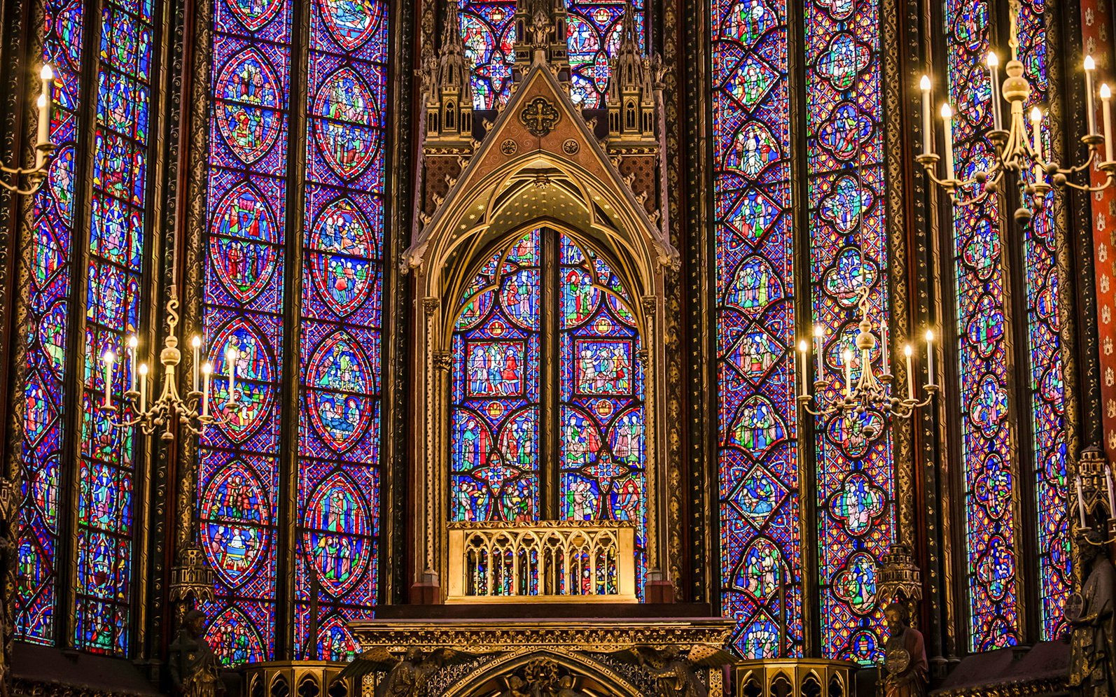 Stained glass windows and chandeliers inside Sainte-Chapelle, Paris.