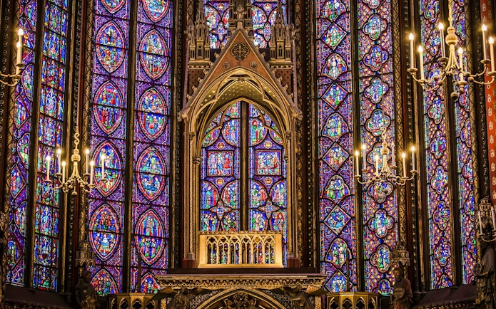 Stained glass windows and chandeliers inside Sainte-Chapelle, Paris.