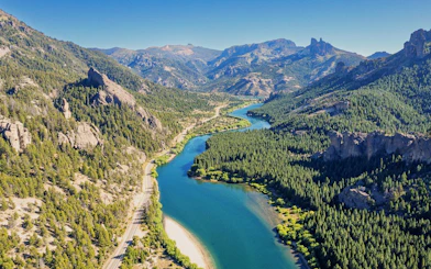 Aerial view of a river winding through a mountain valley in Patagonia.