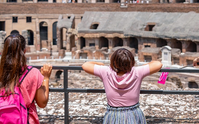 Children observing the interior of the Colosseum in Rome during a family-friendly tour.