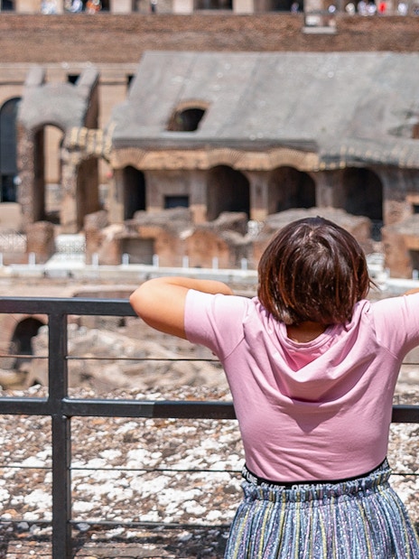 Children observing the interior of the Colosseum in Rome during a family-friendly tour.