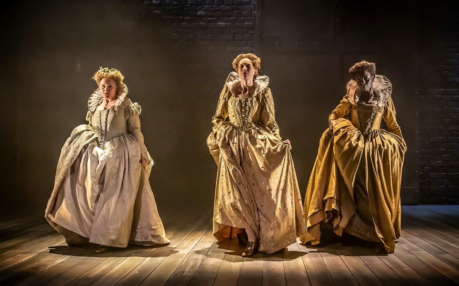 Three actors in period costumes performing on stage in Orlando theater production.