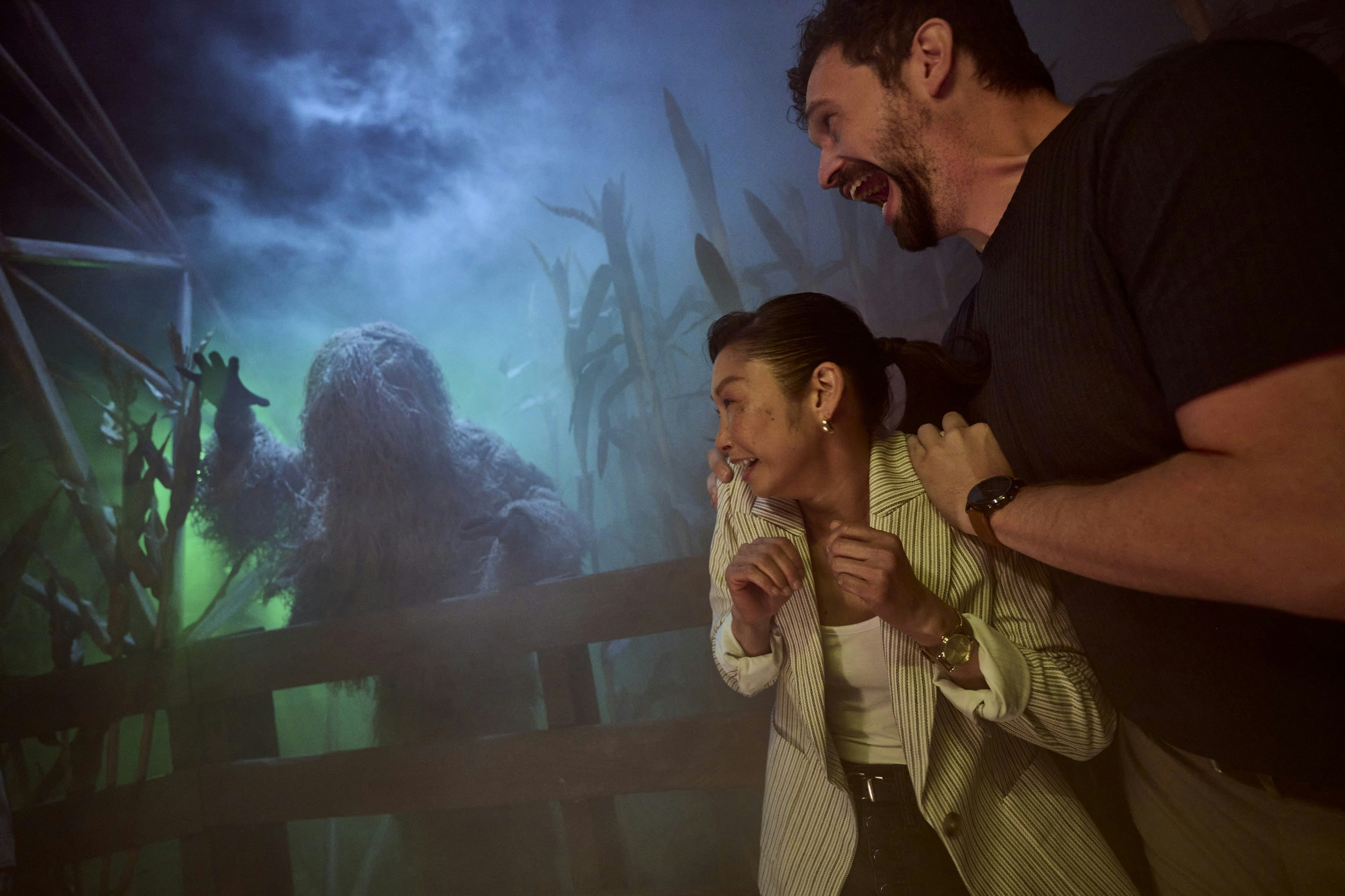 Guests react to a costumed creature at Universal Horror Unleashed in Las Vegas.