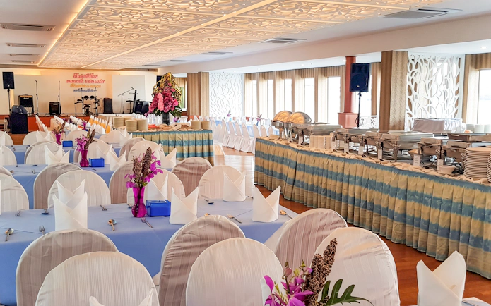 Banquet setup on Riverside Faraya Cruise in Bangkok with dining tables and buffet.