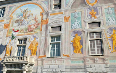 Frescoes on Palazzo San Giorgio facade in Genoa, part of the self-guided city exploration game.