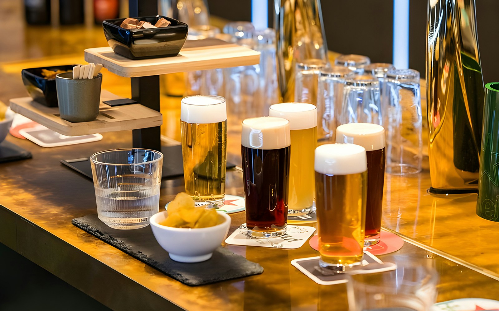 Beer glasses on display at Heineken Experience tour in Amsterdam brewery.