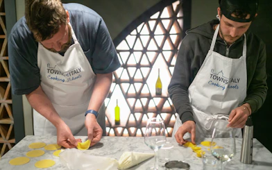 Participants making pasta at a Milan cooking class.