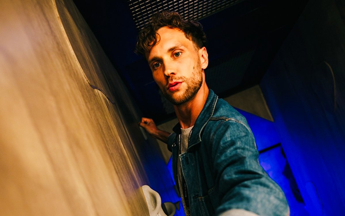 Man exploring an escape room challenge at Prison Island Brisbane.