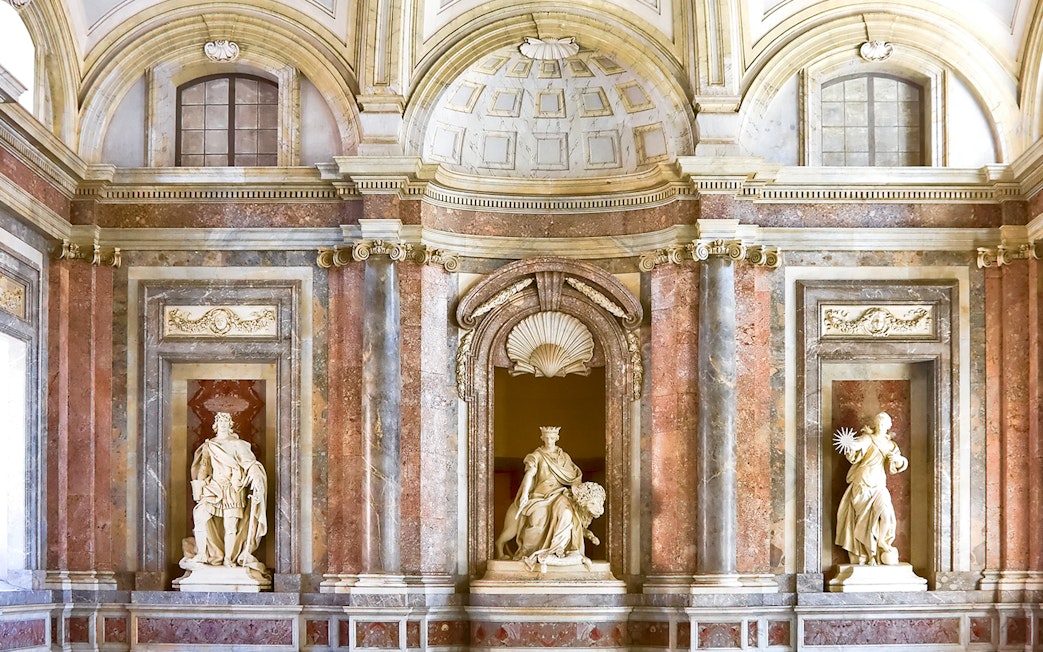 Sculptures atop staircase at Royal Palace of Caserta, Italy.