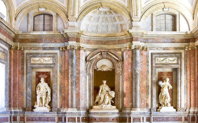 Sculptures atop staircase at Royal Palace of Caserta, Italy.