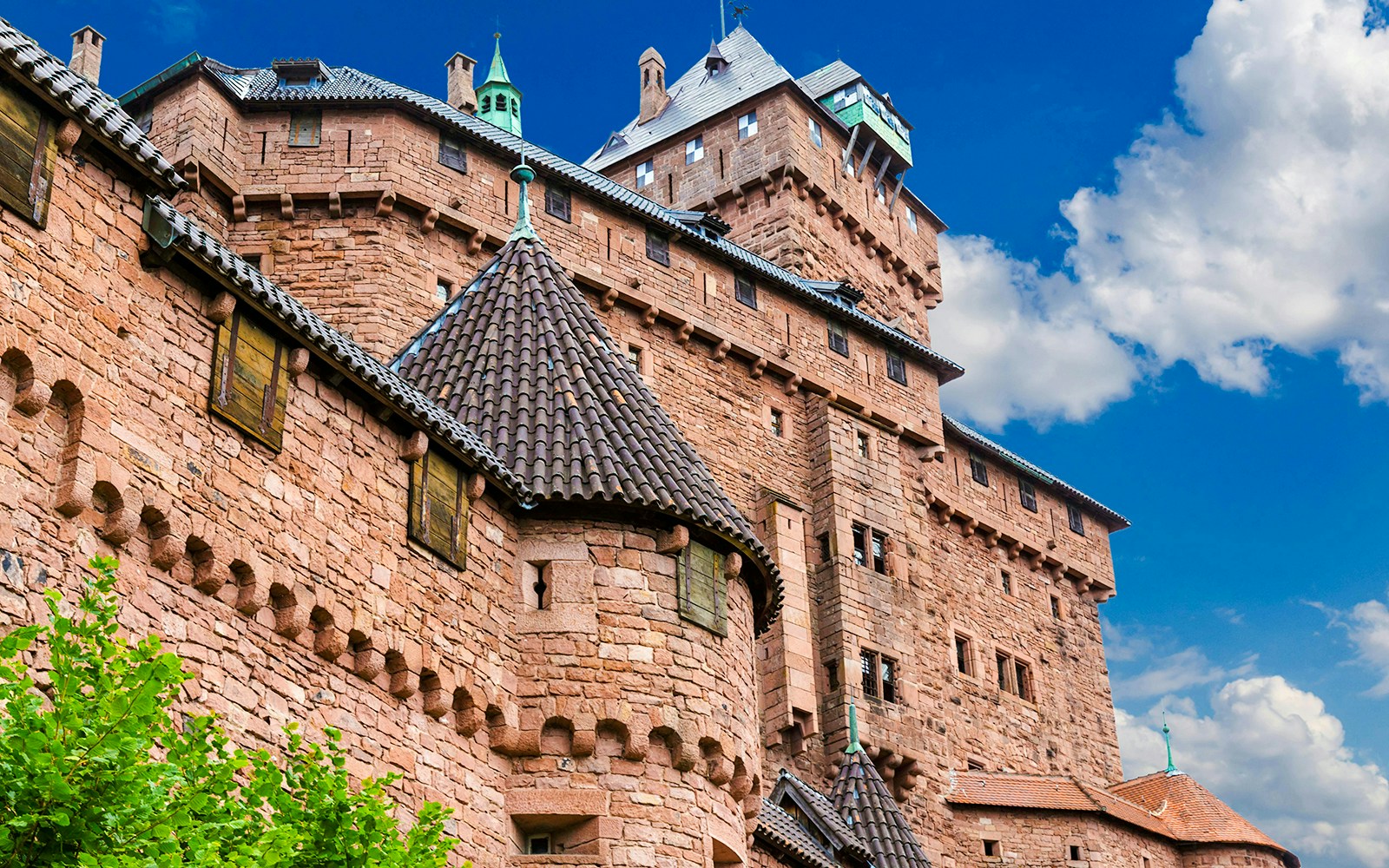 Haut-Koenigsbourg Castle exterior with stone walls and turrets, Alsace, France.
