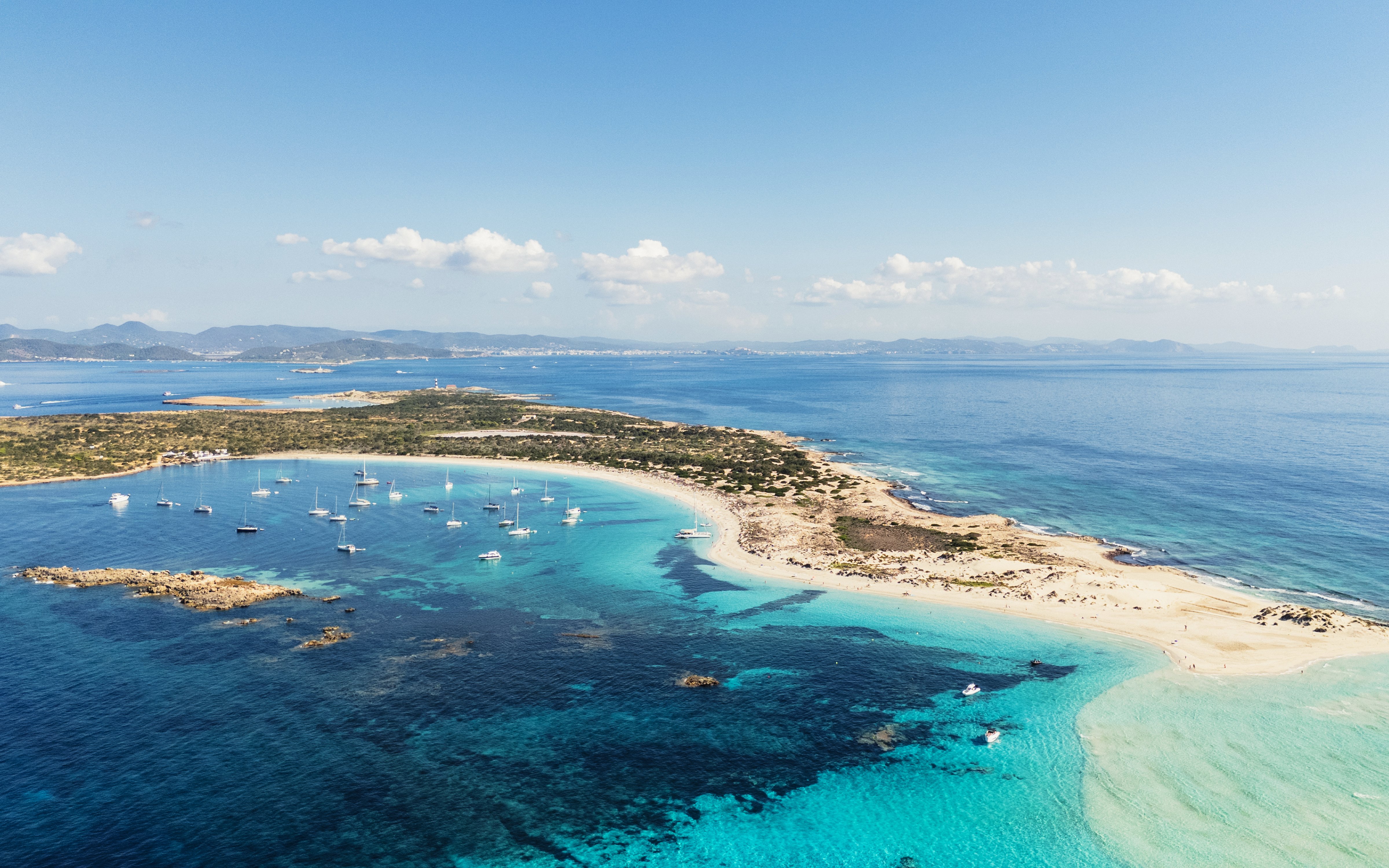 Aerial view of Ibiza island coastline with boats during Formentera Cruise Tour.