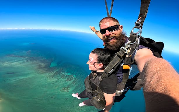 Tandem skydive over Great Barrier Reef, Cairns, with clear blue skies.