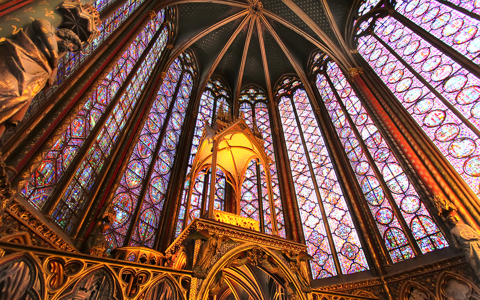 Richly carved column capitals with floral and narrative motifs in Saint Chapelle.