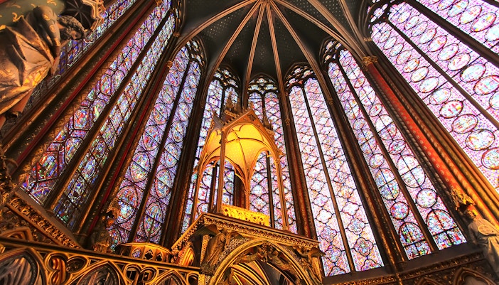 Richly carved column capitals with floral and narrative motifs in Saint Chapelle.