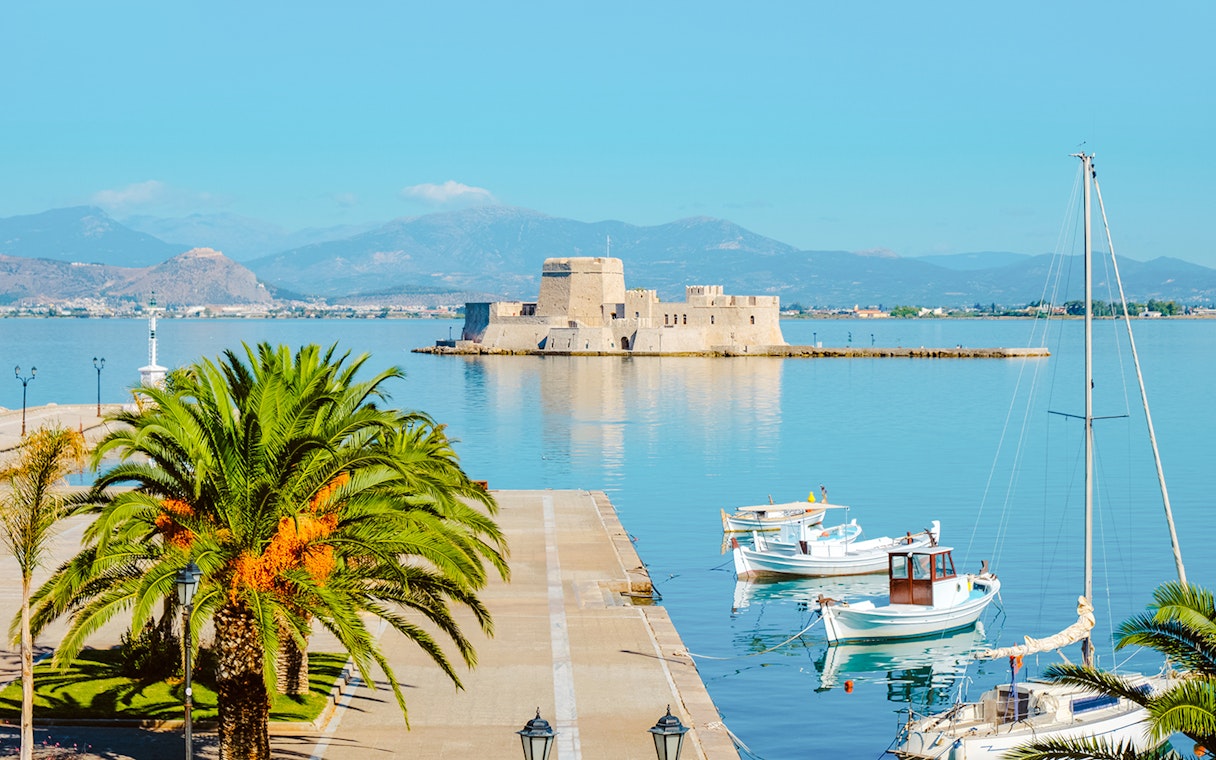 Nafplio port with boats and Bourtzi Castle in Greece.