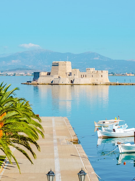 Nafplio port with boats and Bourtzi Castle in Greece.