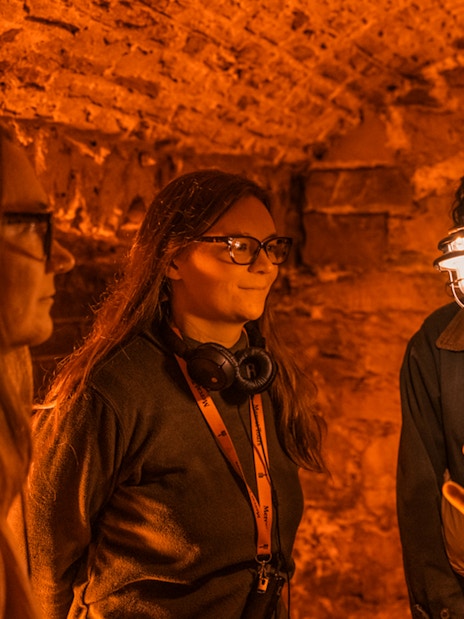 Guide leading a group through Blair Street Underground Vaults.