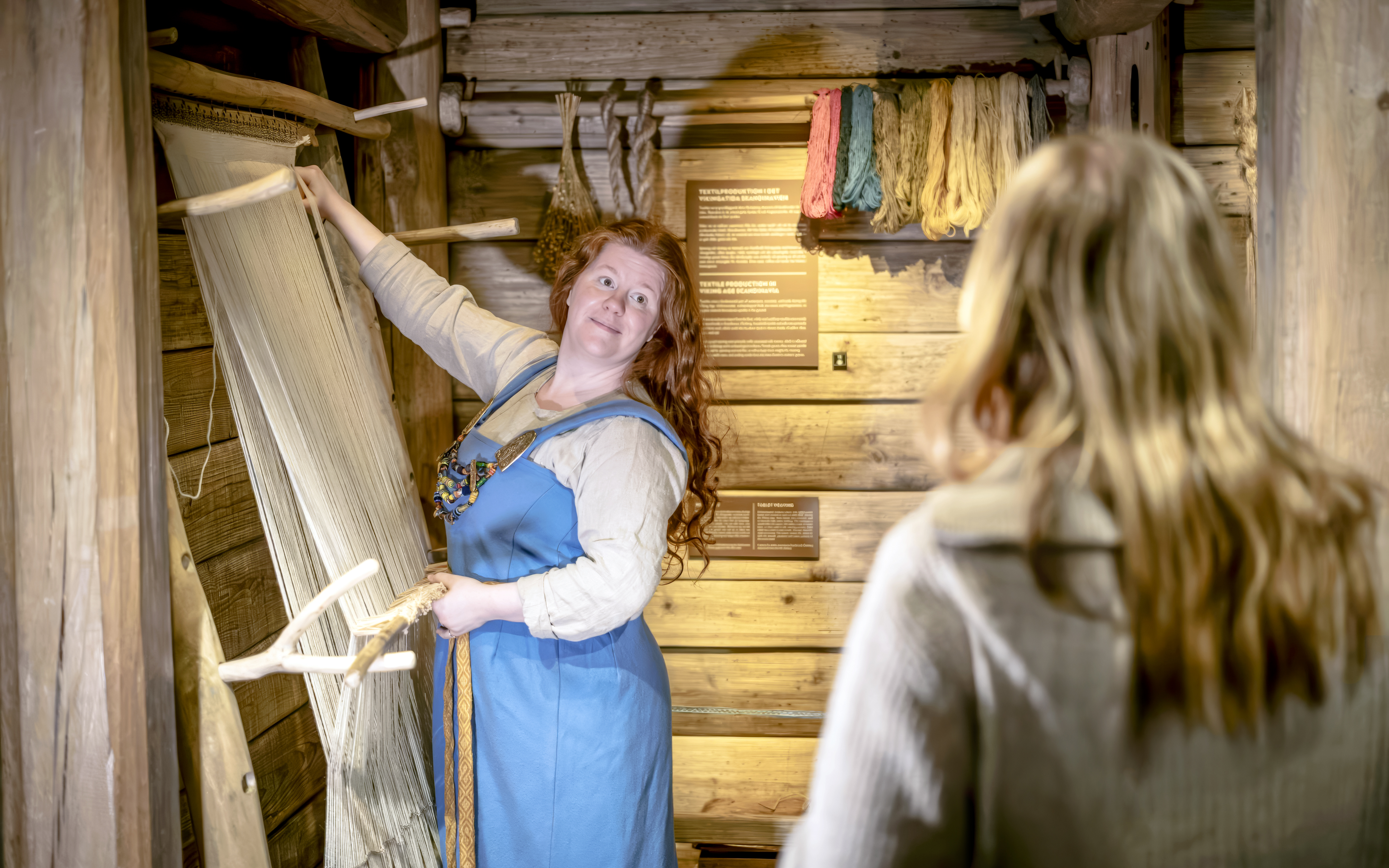 Costumed guide demonstrating weaving at The Viking Museum, Stockholm.