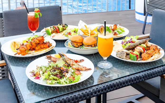 Assorted dishes and drinks on a table at Riva Beach Club, Dubai.