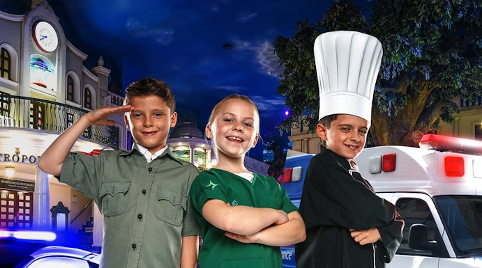 Children in costumes at KidZania Dubai, posing as a police officer, chef, and shopkeeper.