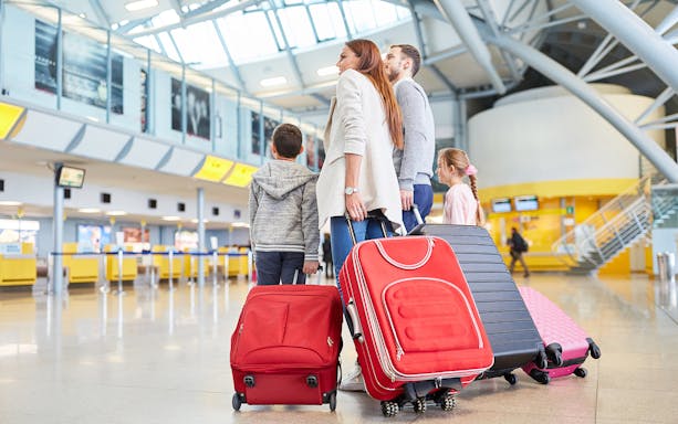 Family with luggage at Katowice Airport for one-way trip to Krakow.