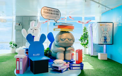 Sculptures of cartoon animals with books at Taipei 101 Observatory exhibit.