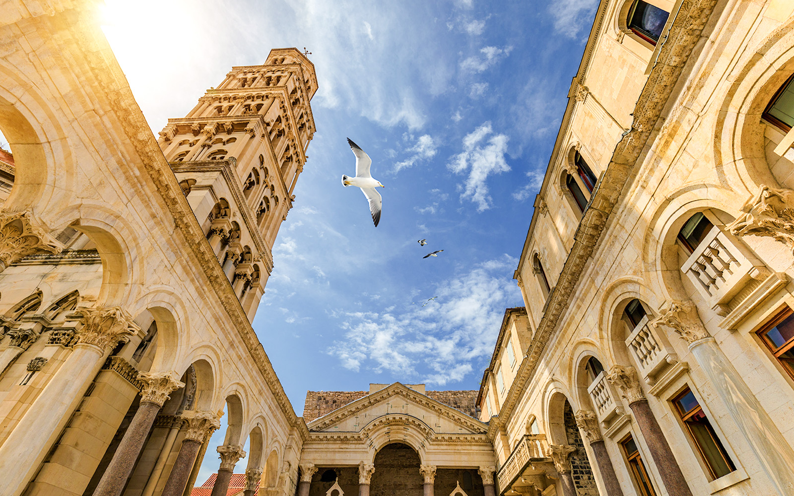 Diocletian's Palace courtyard with bell tower and seagulls in Split, Croatia.