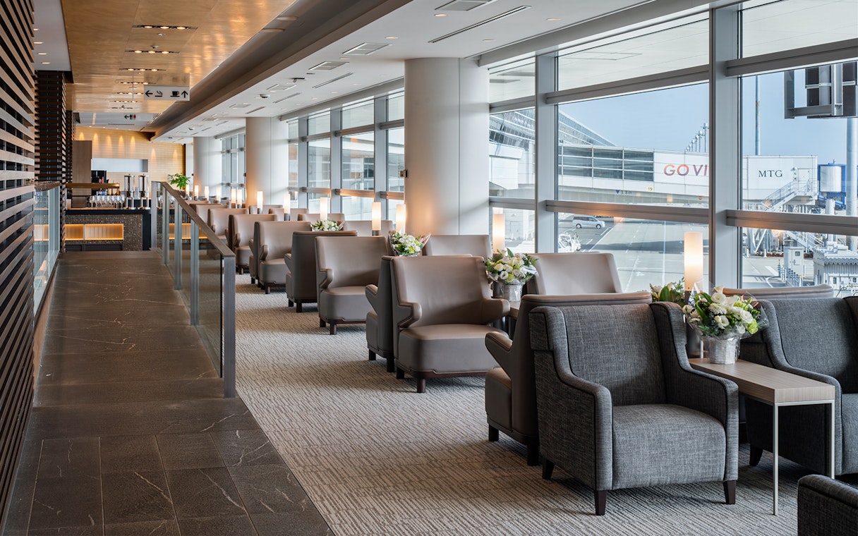 Plaza Premium Lounge seating area at Chubu Centrair International Airport with runway view.