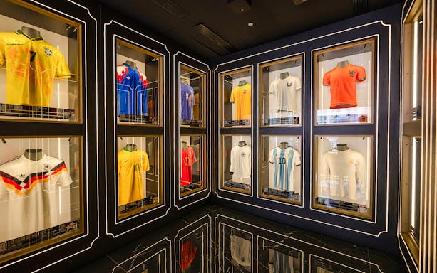 Home of Football Museum Madrid interior with vintage football memorabilia and historic jerseys displayed.