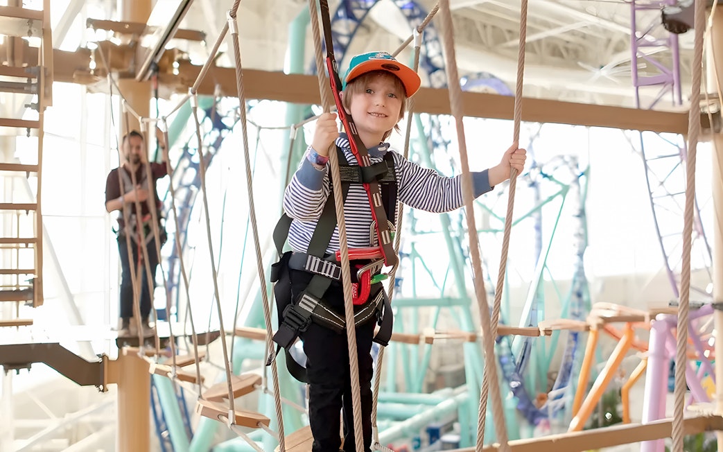 Child navigating ropes course at Legends of the Hidden Temple, American Dream, Nickelodeon Universe.