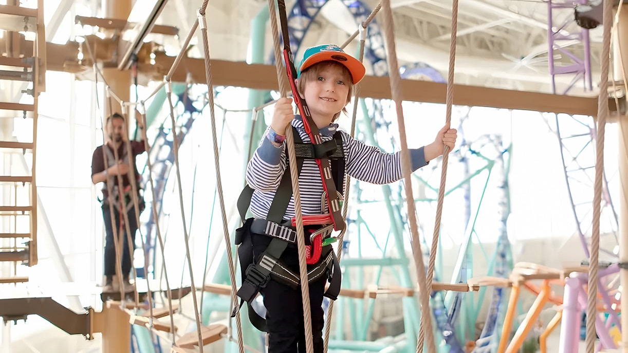 Child navigating ropes course at Legends of the Hidden Temple, American Dream, Nickelodeon Universe.