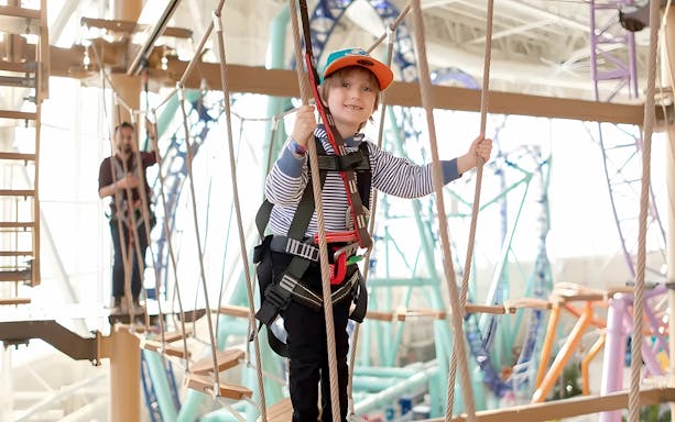 Child navigating ropes course at Legends of the Hidden Temple, American Dream, Nickelodeon Universe.