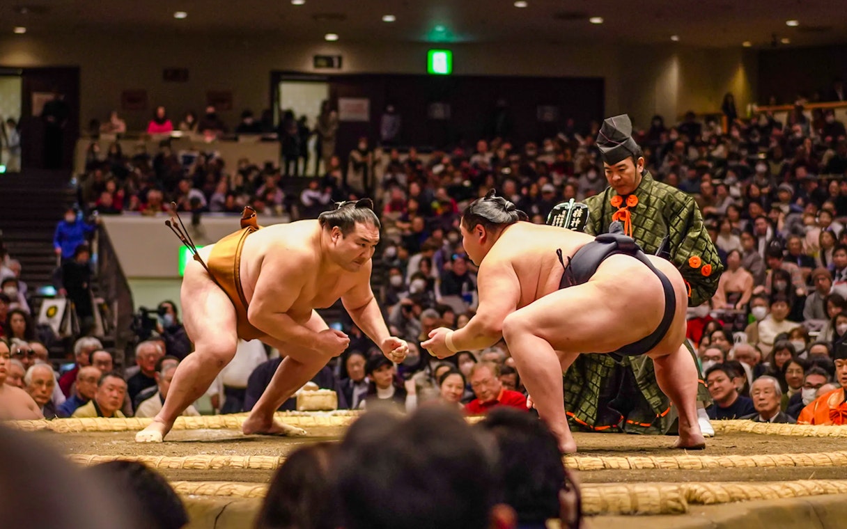 Sumo wrestlers face off in Ryogoku arena during Tokyo tournament.