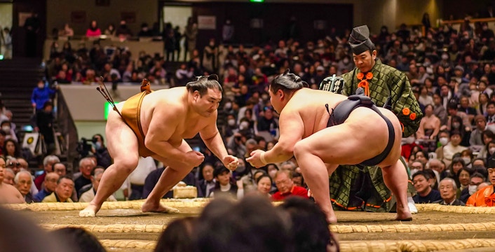 Sumo wrestlers face off in Ryogoku arena during Tokyo tournament.