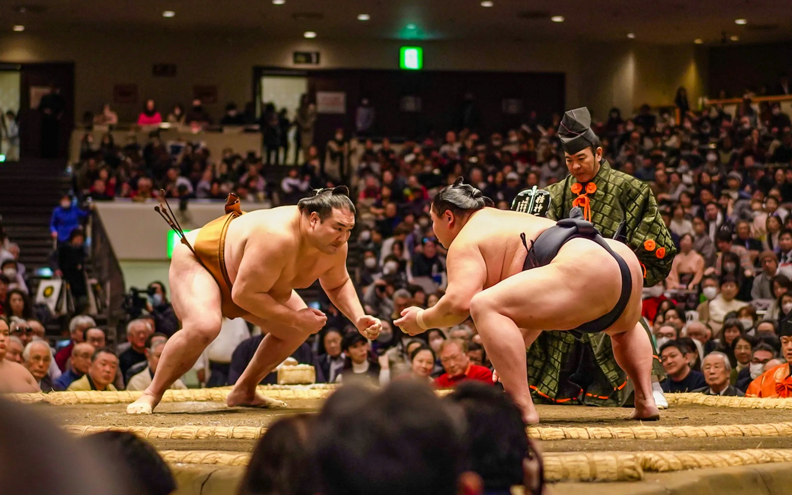 Sumo wrestlers face off in Ryogoku arena during Tokyo tournament.