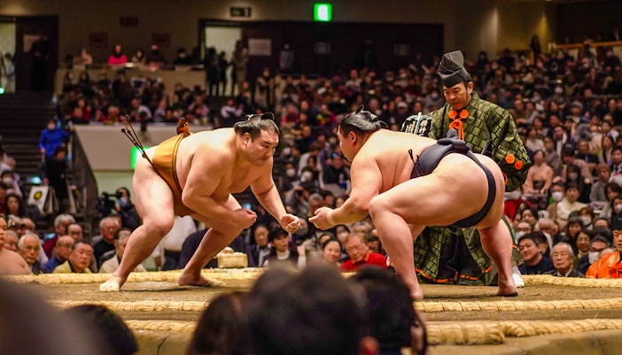 Sumo wrestlers face off in Ryogoku arena during Tokyo tournament.