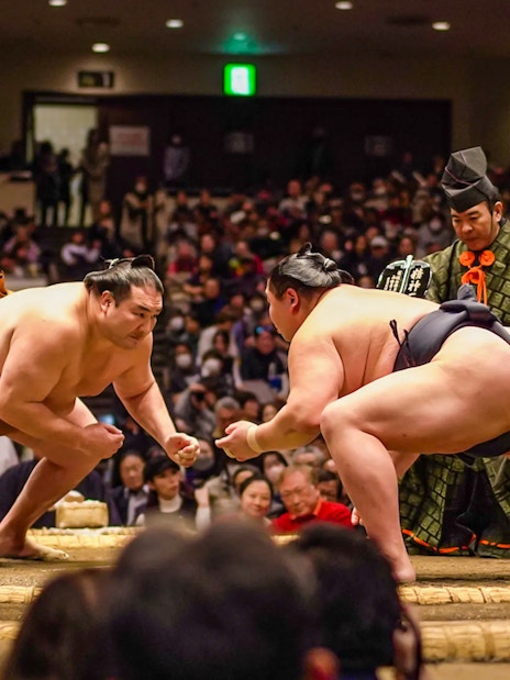 Sumo wrestlers face off in Ryogoku arena during Tokyo tournament.