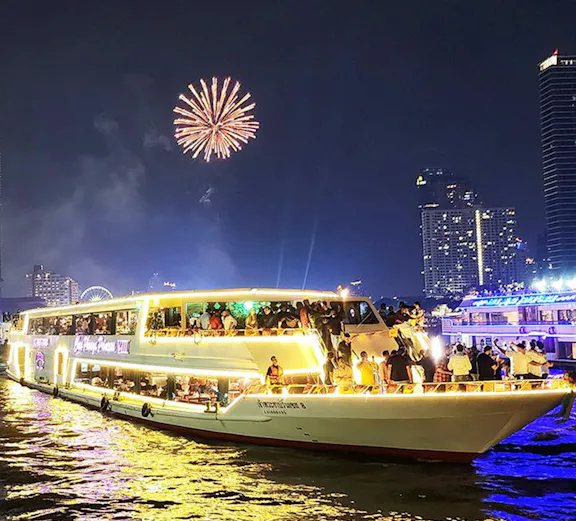 Chao Phraya Princess Cruise with fireworks over Bangkok skyline at night.