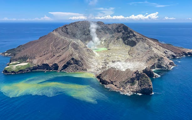 White Island aerial view with volcanic crater and steam, part of guided tour with Mount Tarawera.