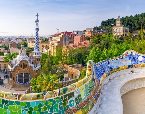 Colorful mosaic terrace and unique architecture at Parc Guell, Barcelona.