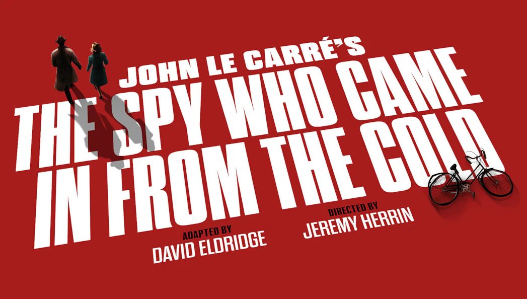 Silhouettes of two figures walking on red background with text 'The Spy Who Came In From The Cold'