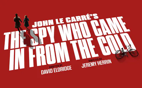 Silhouettes of two figures walking on red background with text 'The Spy Who Came In From The Cold'
