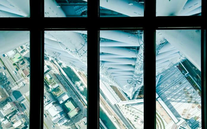 View through glass floor at Tokyo Skytree showing cityscape below.