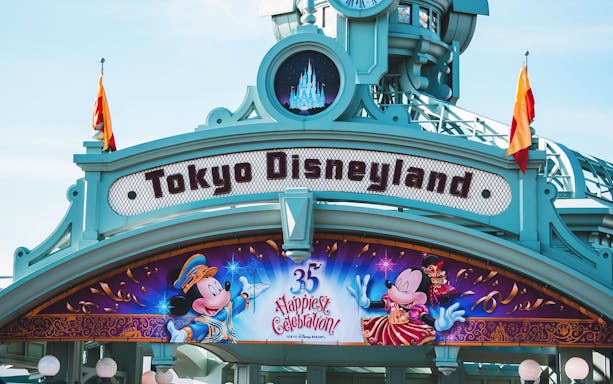 Tokyo Disneyland entrance sign with Mickey and Minnie celebrating 35th anniversary.