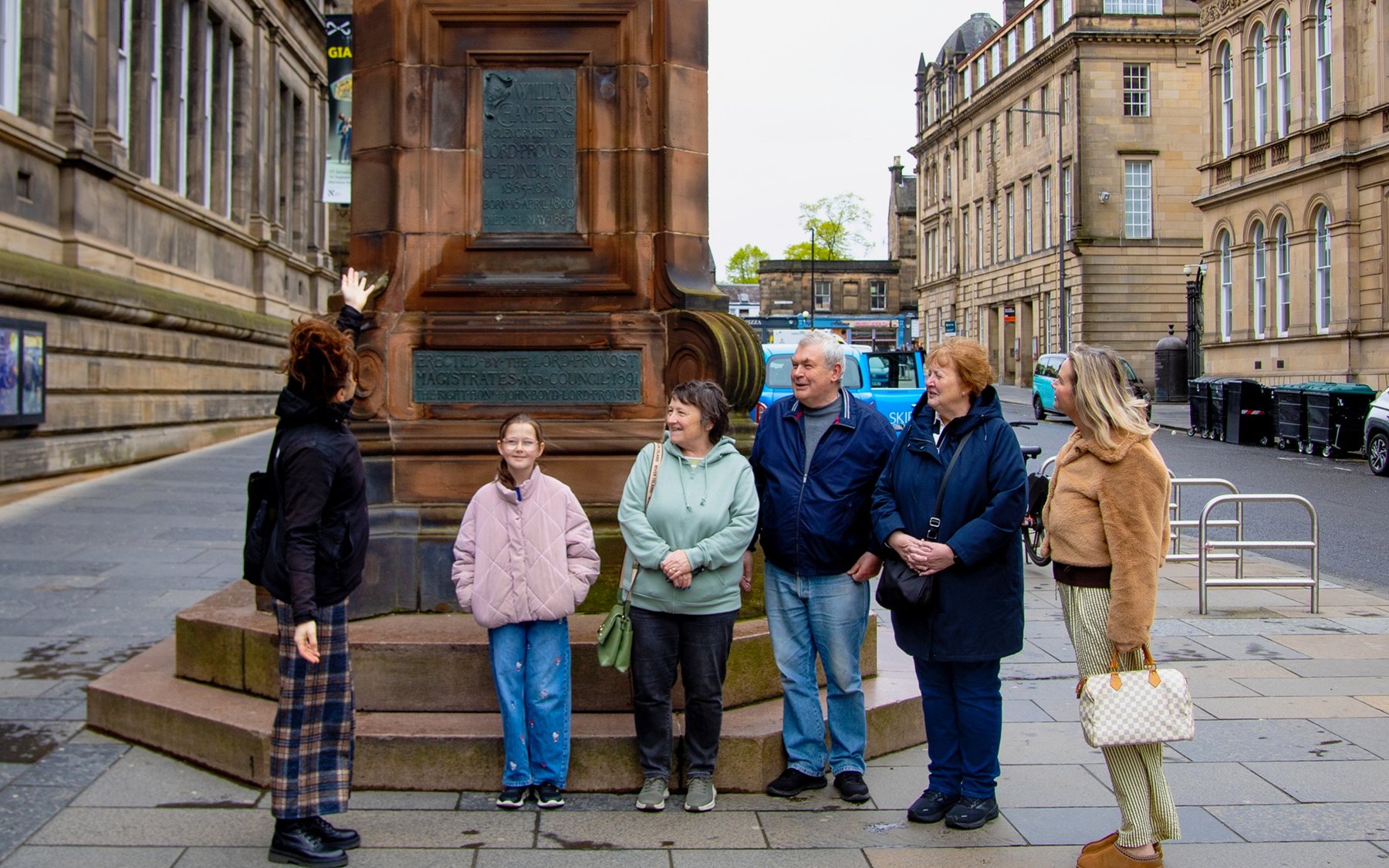 Tour group at a monument during the National Museum of Scotland guided tour in Edinburgh.